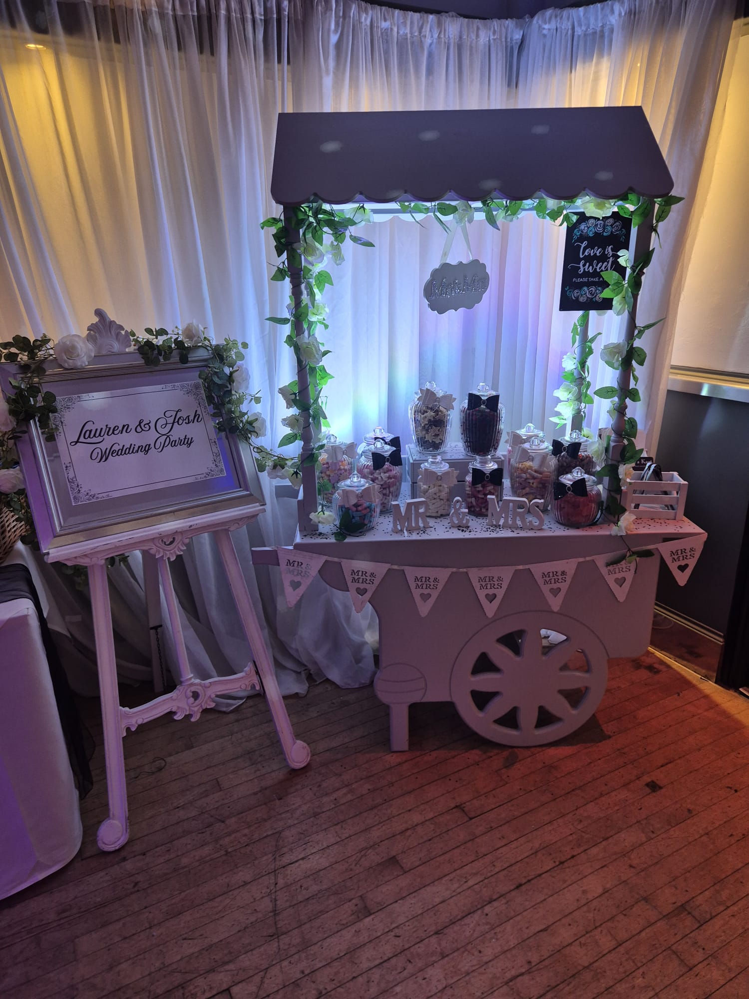 Sweet cart and welcome sign at a Sussex wedding reception