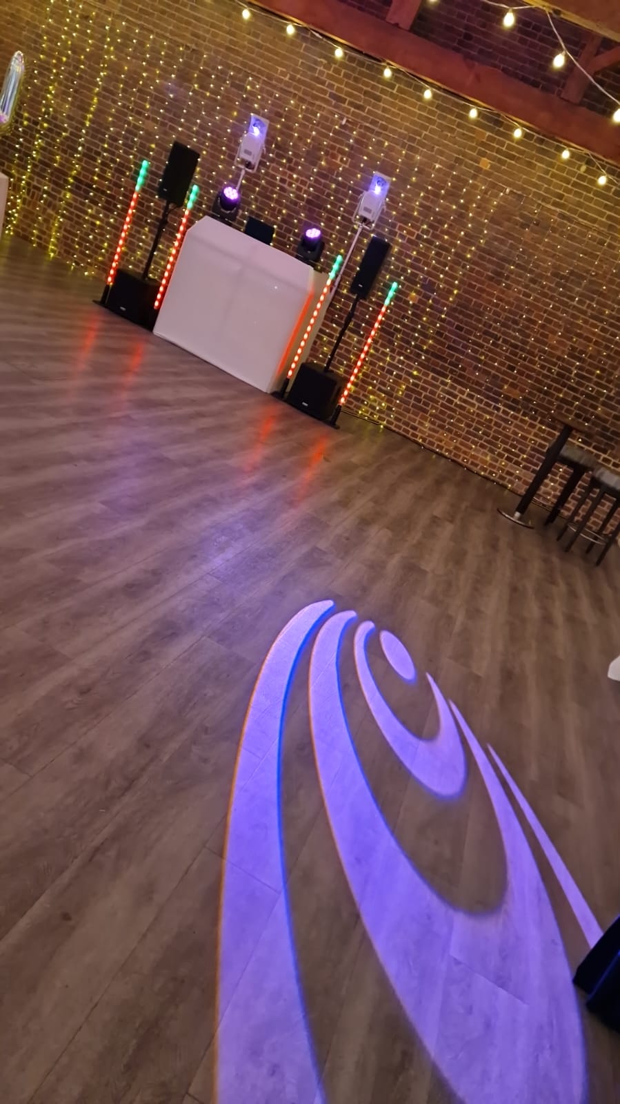 White DJ booth and lighting in a barn venue in Sussex