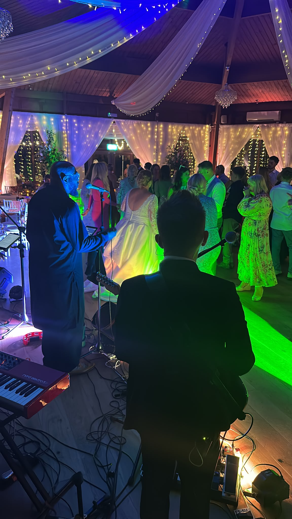 Live band playing as the bride dances at a Sussex wedding reception