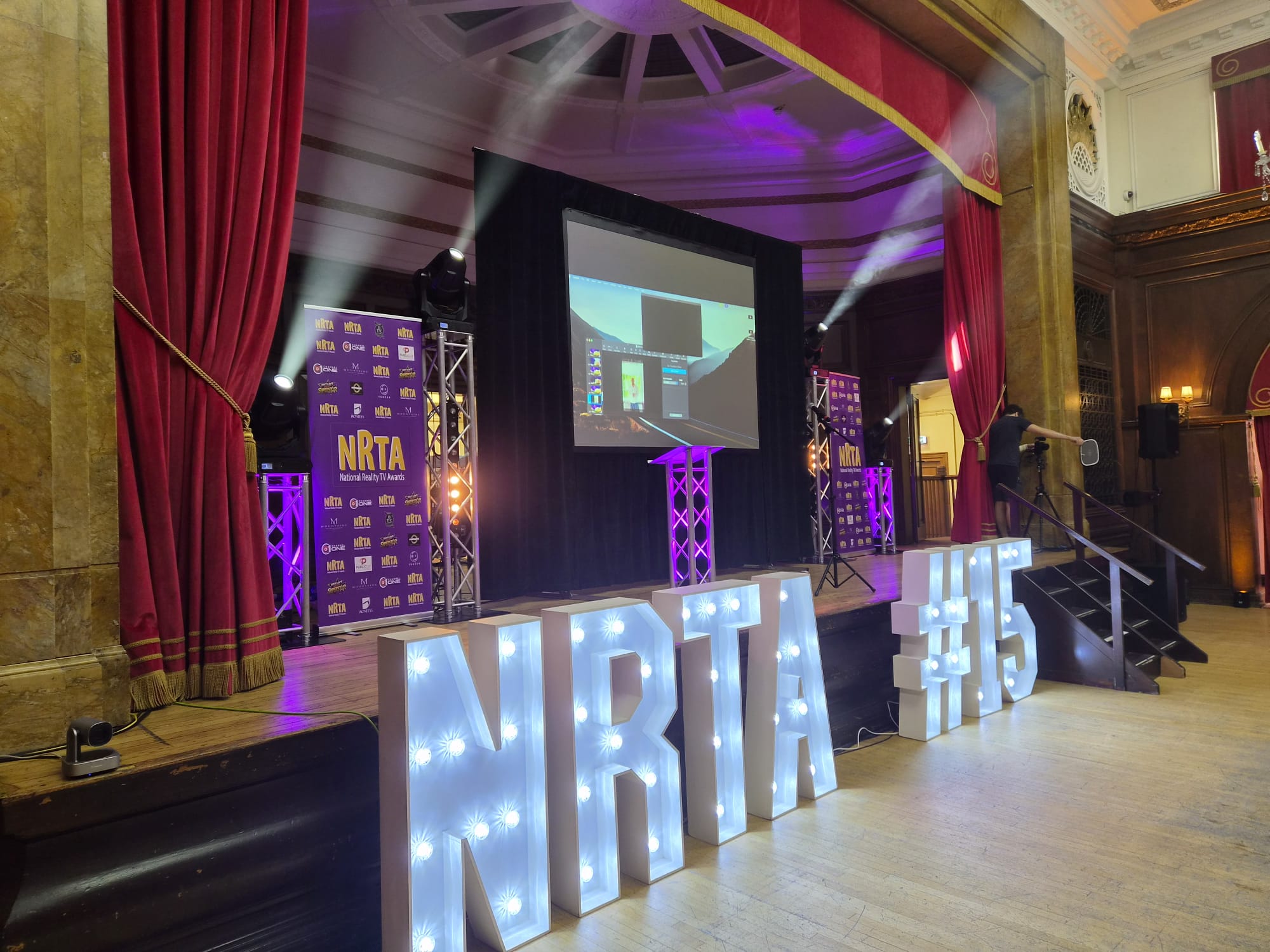 Stage lighting, truss and light-up letters at an awards event