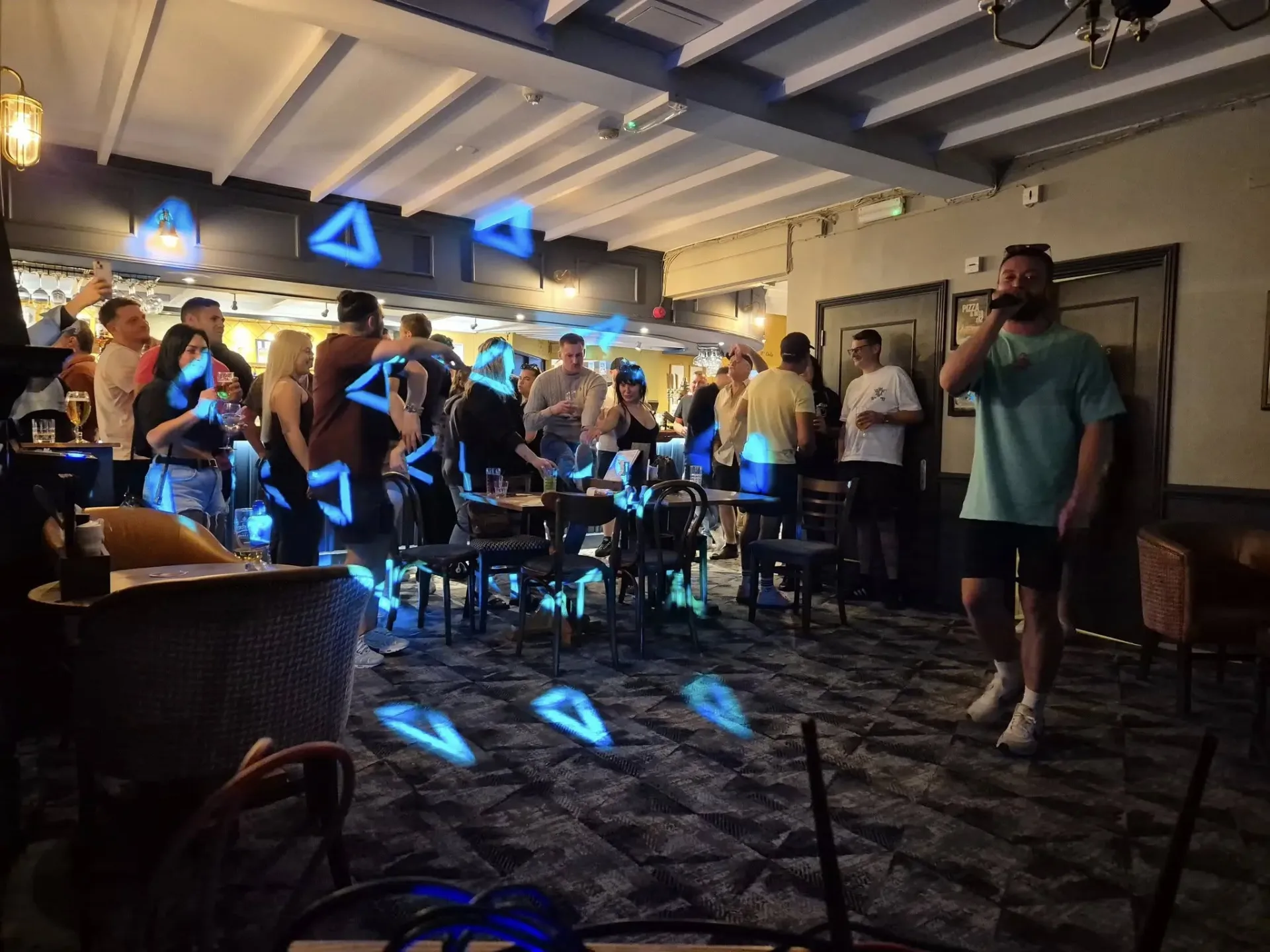 Guest singing karaoke with blue party lighting